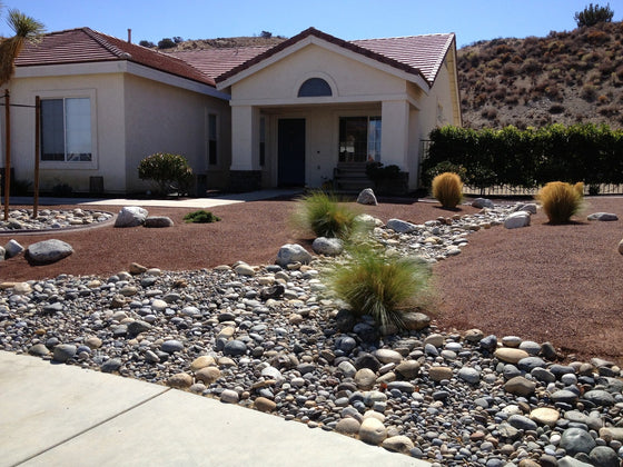Well-kept landscape rock and decomposed granite front yard
