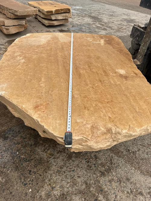 Arizona Buckskin Gold sandstone mega slab, deep amber gold face, at the stone yard