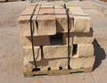 Pallet of Arizona Buckskin Gold sandstone wall block in warm tan and light beige, strapped and ready for delivery