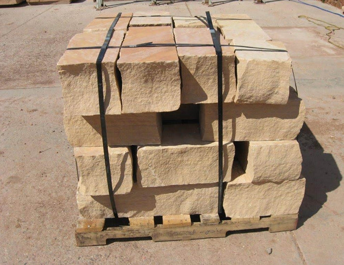 Pallet of Arizona Buckskin Gold sandstone wall block in warm tan and light beige, strapped and ready for delivery