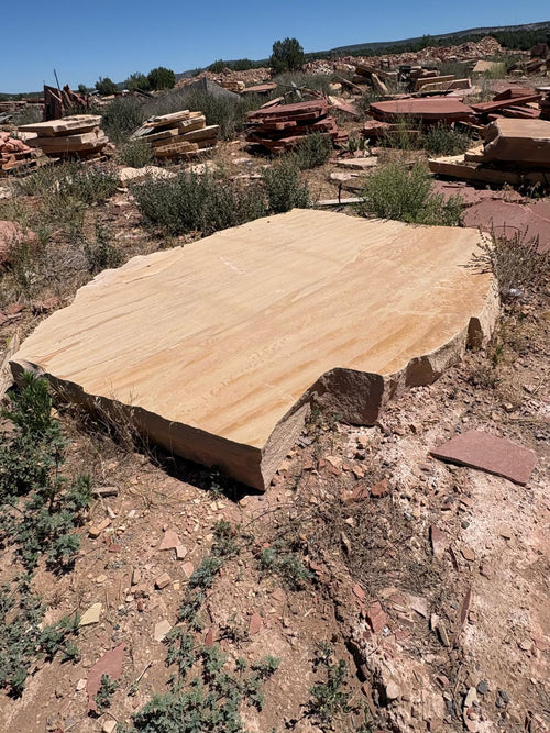 Arizona Buckskin sandstone mega slab at the quarry, warm tan with soft gold banding