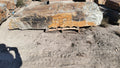 Autumn Creek boulder, a large flat gold and gray slab on a pallet at the stone yard