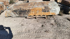 Autumn Creek boulder, a large flat gold and gray slab on a pallet at the stone yard