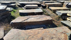 Autumn Creek boulders, flat layered slabs laid out at the stone yard