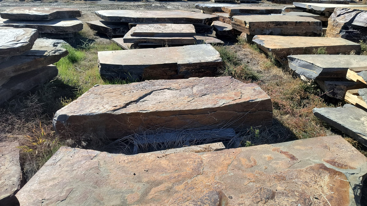 Autumn Creek boulders, flat layered slabs laid out at the stone yard