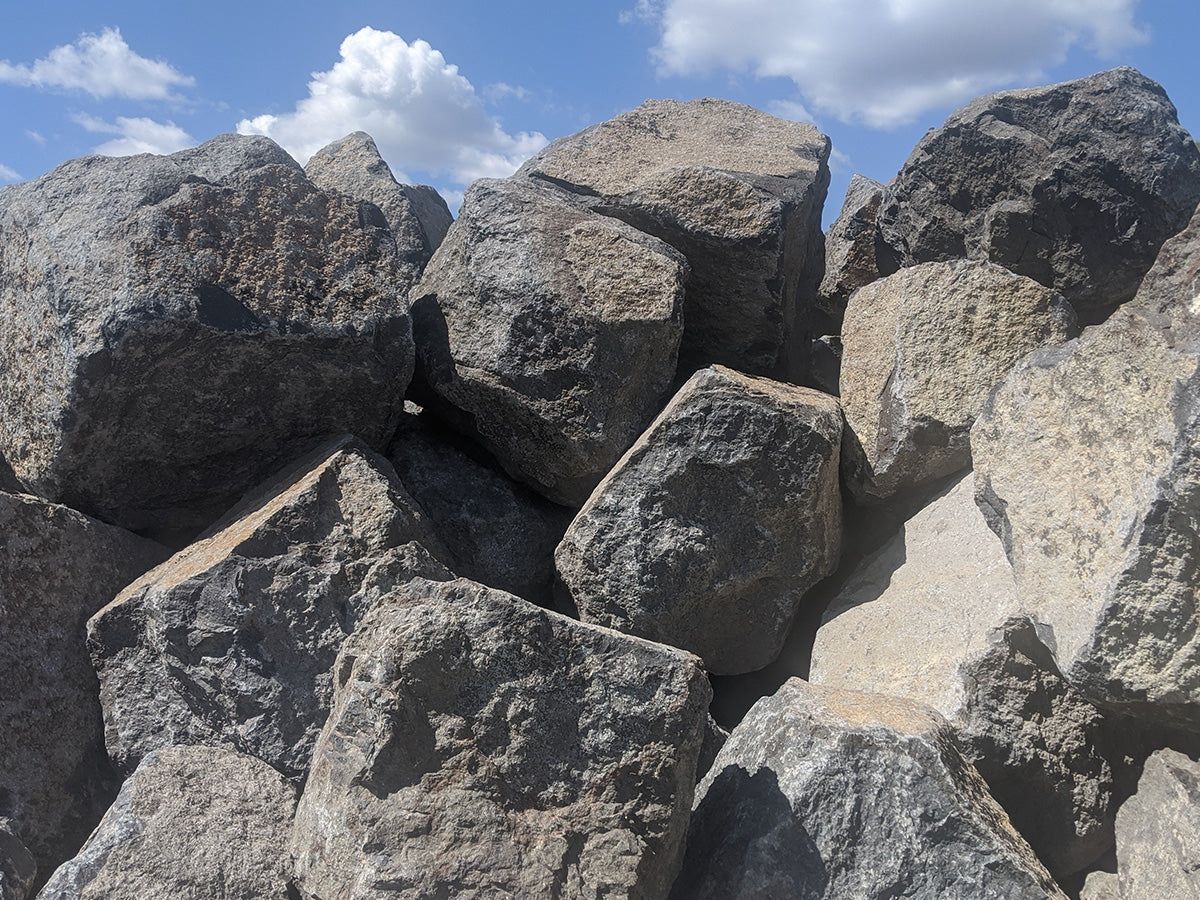 Black basalt boulders 18 to 24 inches, sized for planting beds and edging