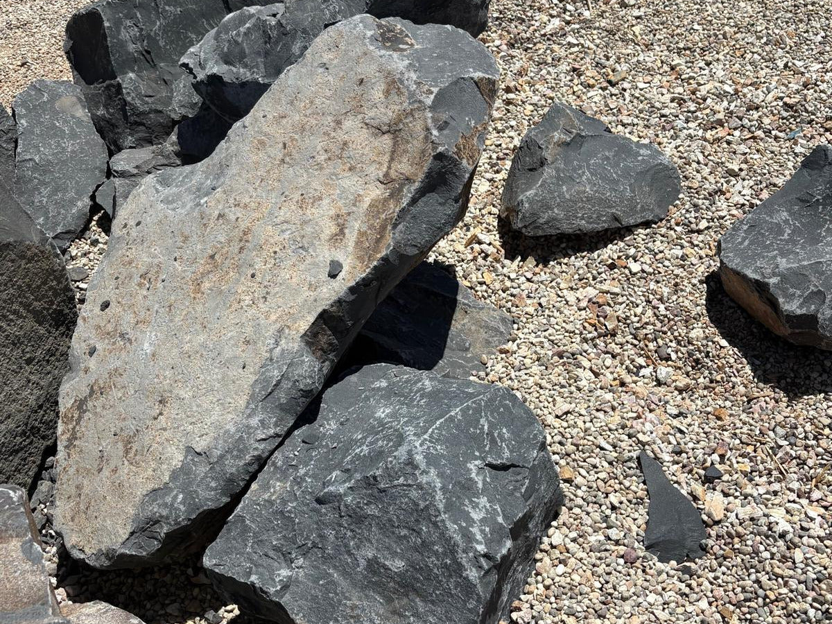 Black Hawk shale boulders with pale weathered faces, quarried in Central California