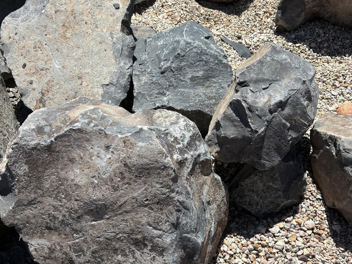 Close-up of a Black Hawk boulder showing its flat fractured face and grey-black shale texture