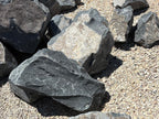 Pile of Black Hawk decorative boulders with angular broken faces at the stone yard