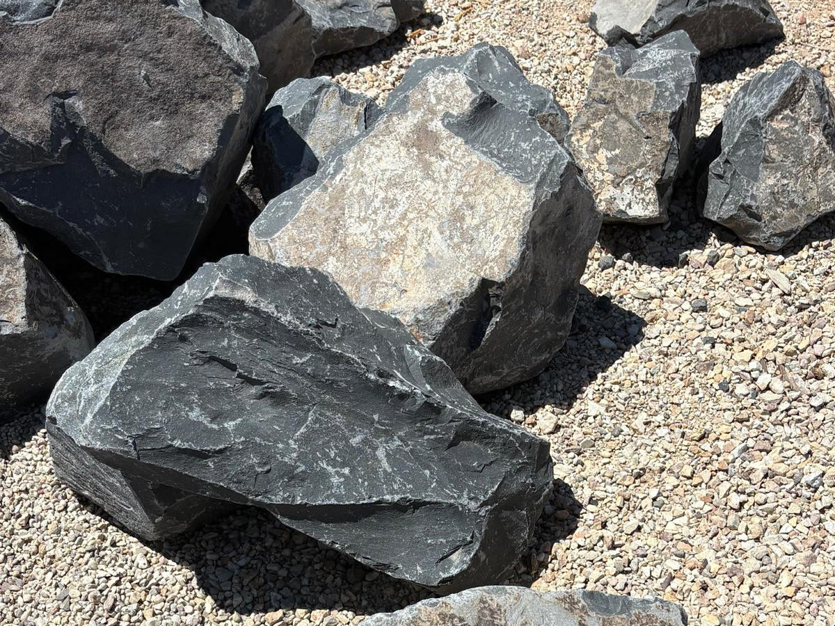Pile of Black Hawk decorative boulders with angular broken faces at the stone yard