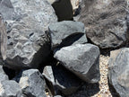 Stacked Black Hawk boulders sized for landscape accents and garden borders