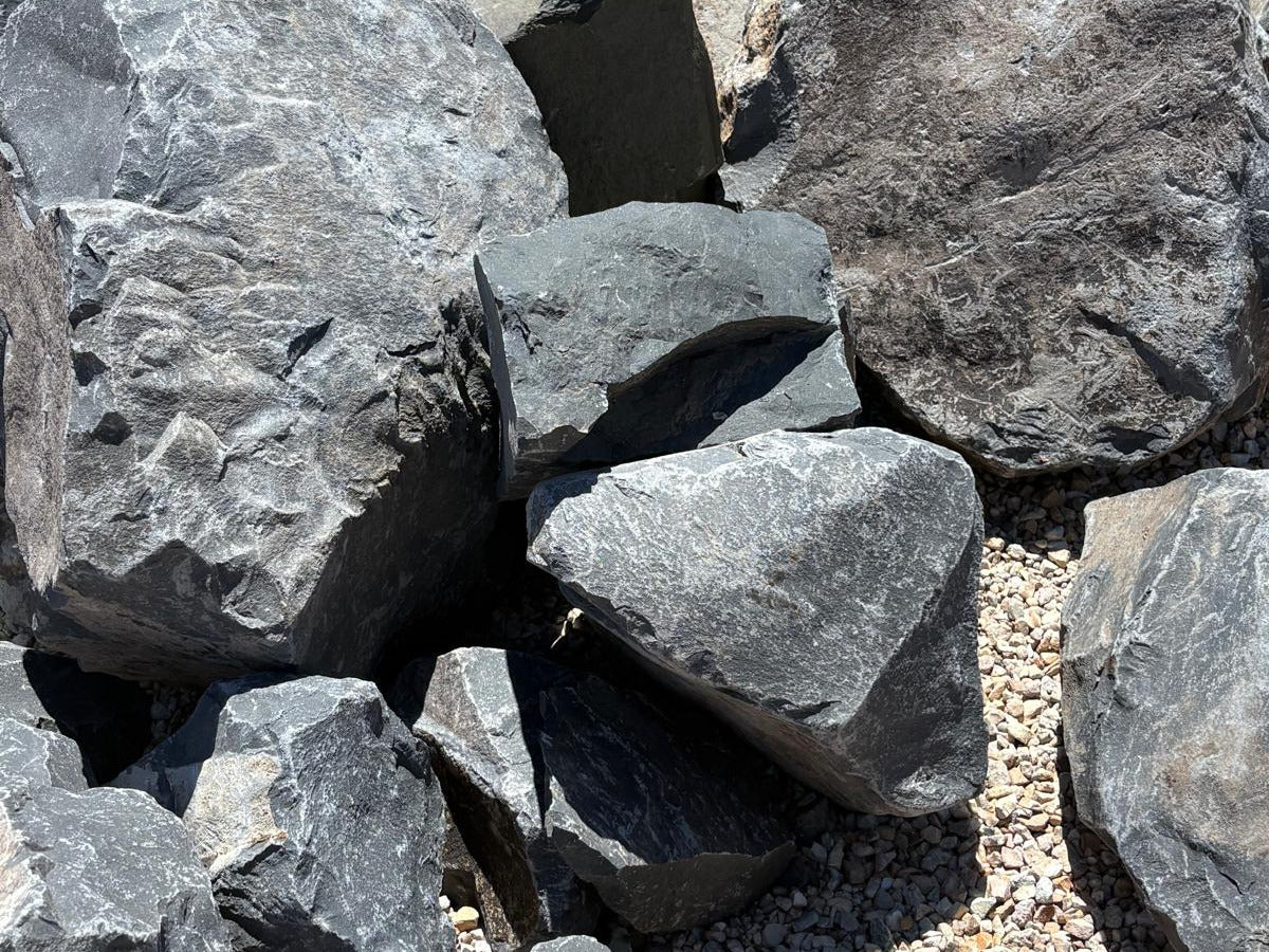 Stacked Black Hawk boulders sized for landscape accents and garden borders