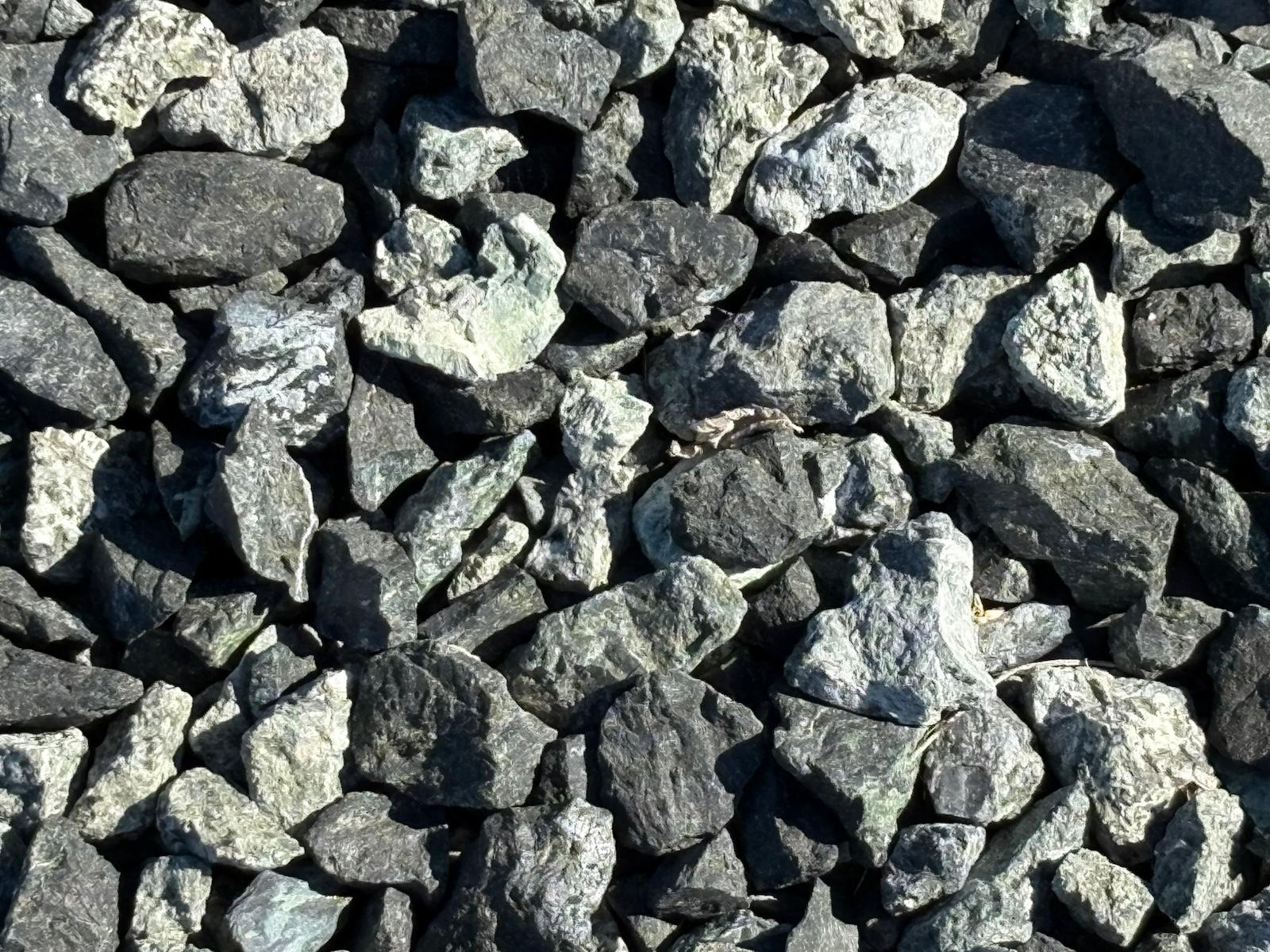 Close up of Black n Silver Rock 1 inch crushed landscape rock showing charcoal black stone flecked with silver gray
