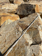 Close-up of Carmel Gold Granite surface, gold and rust over blue-grey granite
