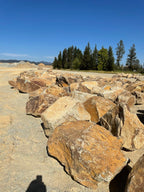 Carmel Gold Granite landscape boulders lined up in the quarry yard
